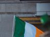 Man holding the Irish flag.