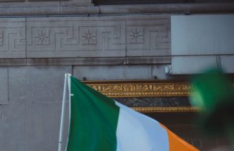 Man holding the Irish flag.